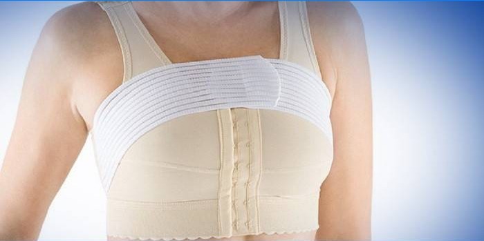 Girl in compression underwear after mammoplasty