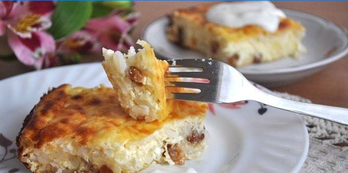 Slice of sweet cottage cheese and rice casserole with raisins