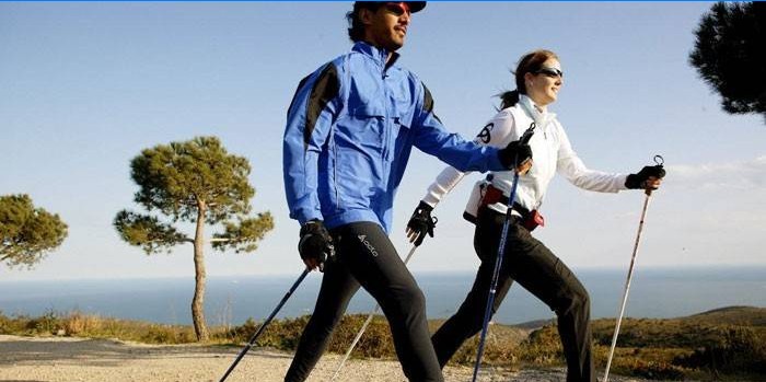 Man and woman are engaged in Nordic walking.