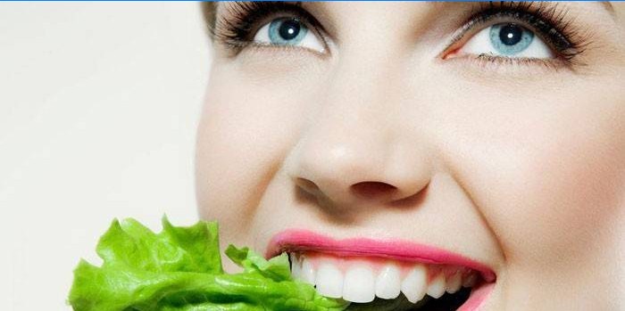 Girl eats lettuce