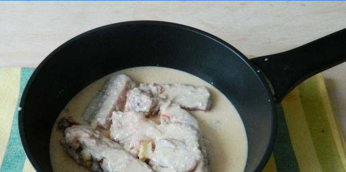 Pork ribs in a creamy sauce in a pan