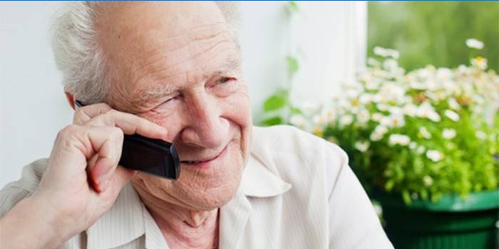 Elderly man talking on a cell phone