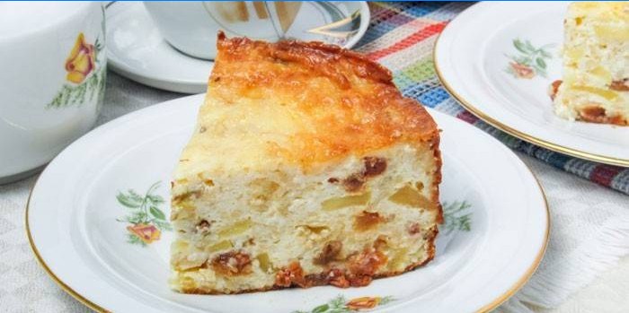 Slice of cottage cheese casserole with raisins and apples