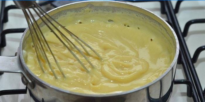 Custard in a pan and whisk
