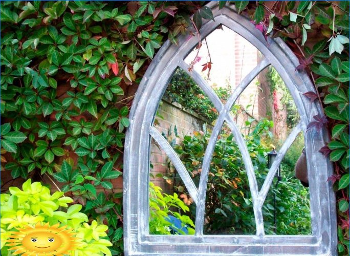 Mirror in the garden as an unusual detail of landscape design