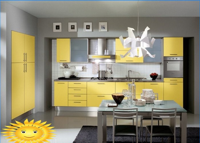 Yellow kitchen facades against the background of gray walls