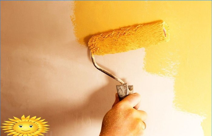 Applying acrylic latex paint to the wall