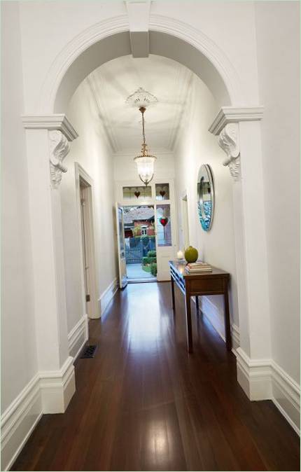 An archway in a hallway with high ceilings