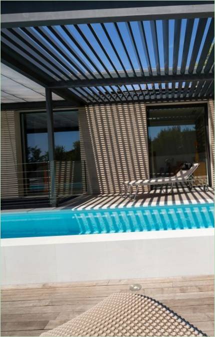 The sitting area by the pool under the lattice canopy