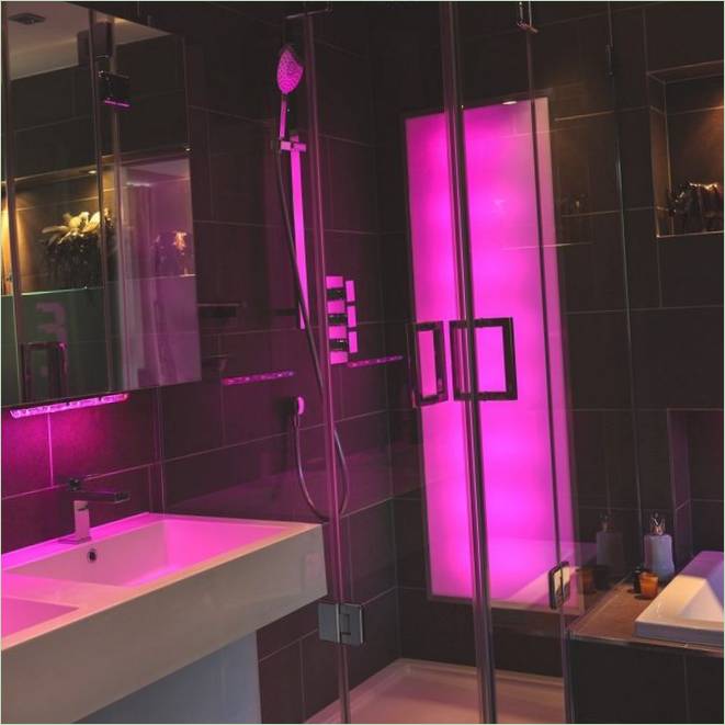 A bathroom with a neon panel